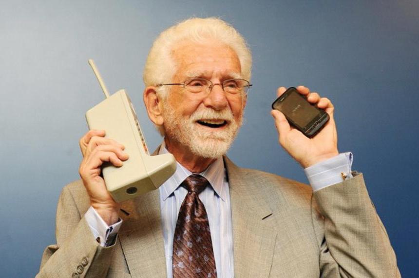 A photo of Marty Cooper holing a cell phone