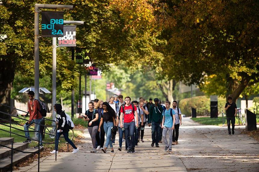 Multiple students walking on Footlick Lane on Mies Campus