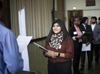 A student speaks to a potential employer at a career fair