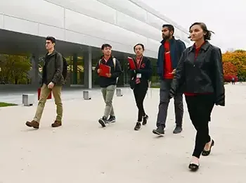 five students walking along the Kaplan Institute