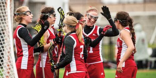 Women's lacrosse team giving each other a high five