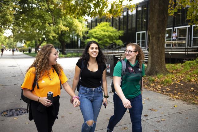 Multiple female students walking on campus