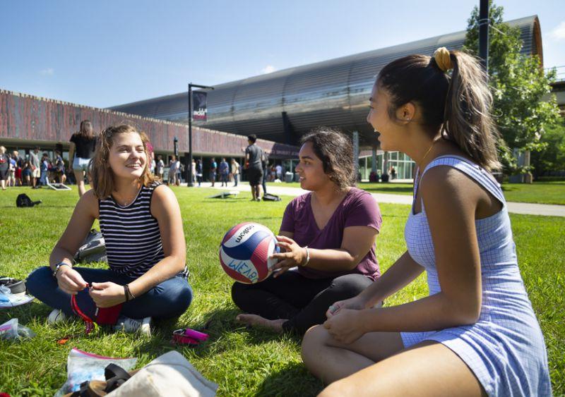 Three students hang out outside of MTCC
